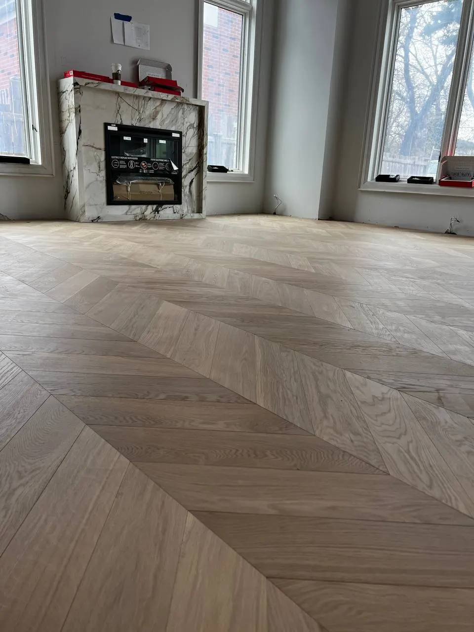 Herringbone 5×25", Soft White, Yorkville hardwood flooring project by Floors Toronto