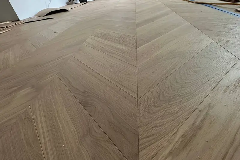 Herringbone 5×25", Soft White, Yorkville hardwood flooring project by Floors Toronto