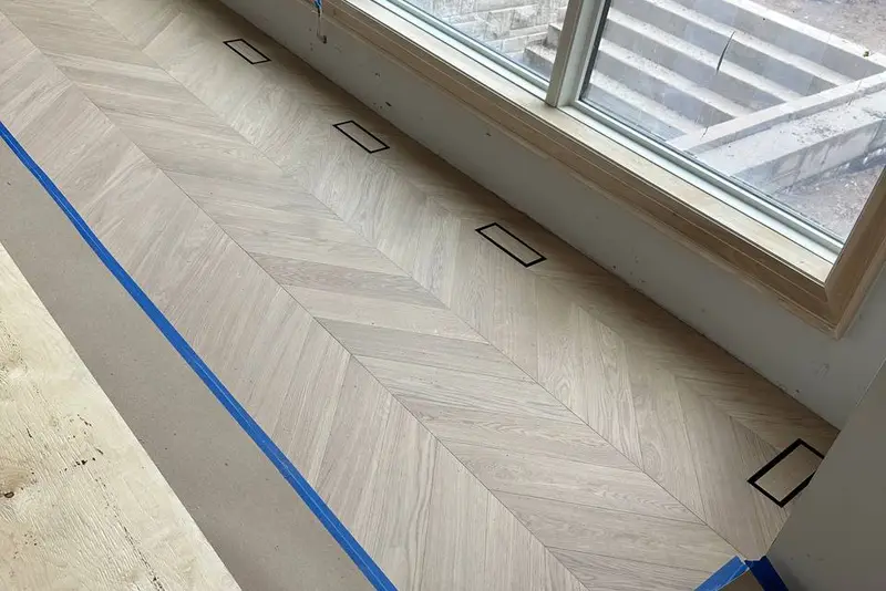 Herringbone 5×25", Soft White, Yorkville hardwood flooring project by Floors Toronto